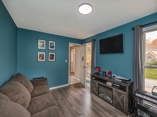 living room featuring dark hardwood / wood-style floors and a textured ceiling