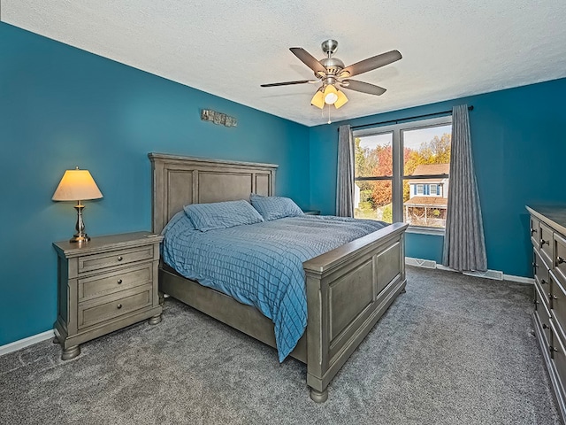 carpeted bedroom with a textured ceiling and ceiling fan