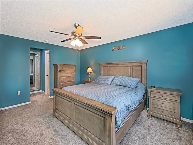 bedroom with ceiling fan, carpet, and a textured ceiling