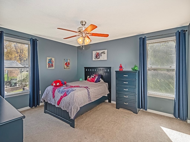 carpeted bedroom featuring a textured ceiling and ceiling fan