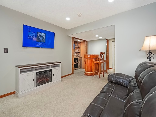 living room with bar area, a textured ceiling, and light colored carpet