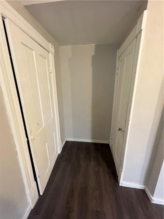 corridor with dark wood-type flooring