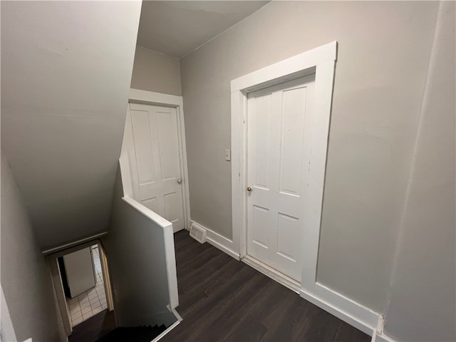 hallway with dark hardwood / wood-style flooring