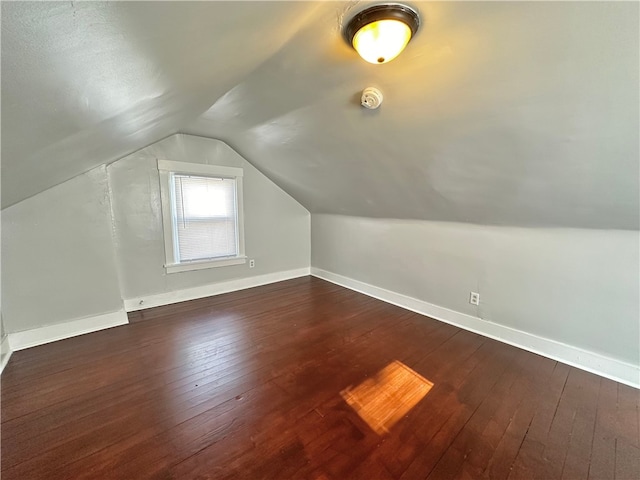 additional living space with lofted ceiling and dark hardwood / wood-style floors