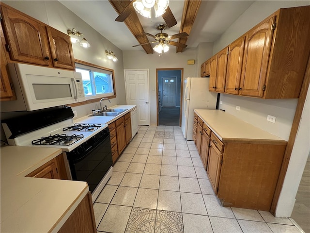 kitchen with white appliances, sink, ceiling fan, beam ceiling, and light tile patterned floors