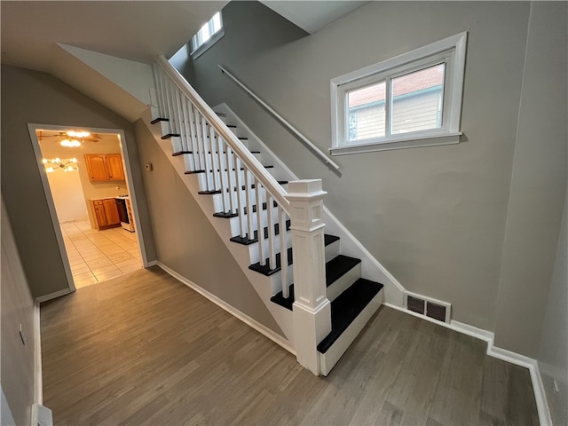 stairs featuring hardwood / wood-style floors