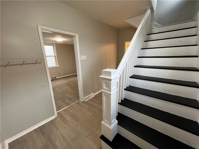 stairway featuring wood-type flooring