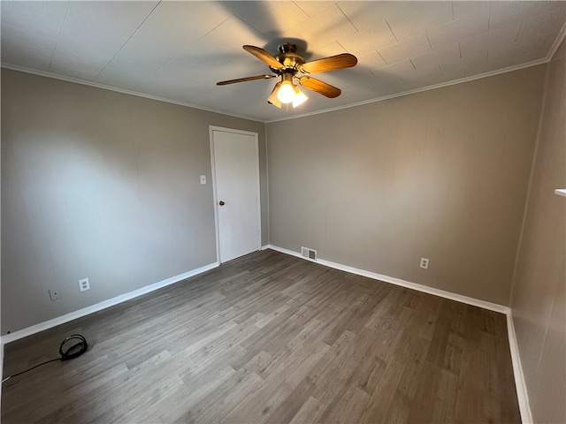 unfurnished room featuring ceiling fan, wood-type flooring, and ornamental molding