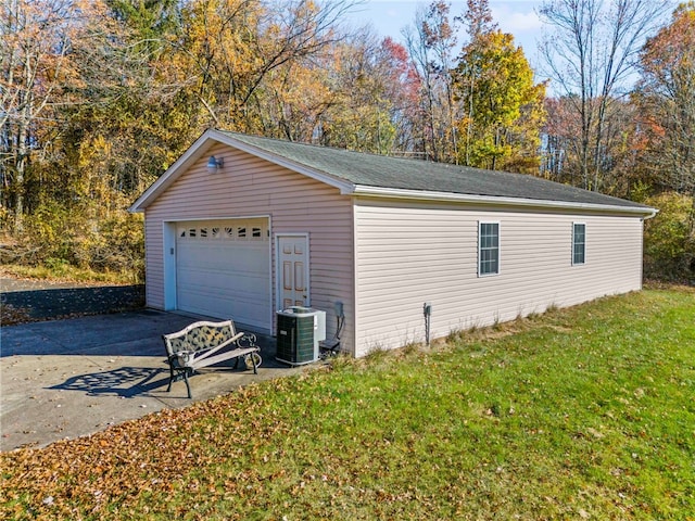 garage featuring a yard and cooling unit