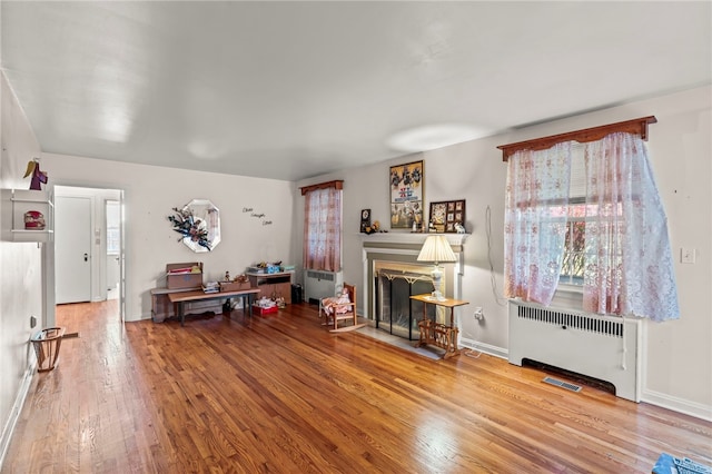 miscellaneous room with radiator heating unit and hardwood / wood-style floors