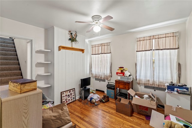 interior space with ceiling fan and wood-type flooring