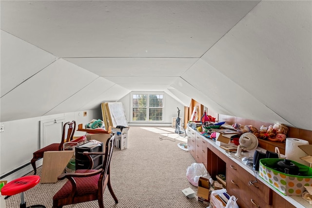 additional living space featuring vaulted ceiling, a baseboard heating unit, and carpet floors