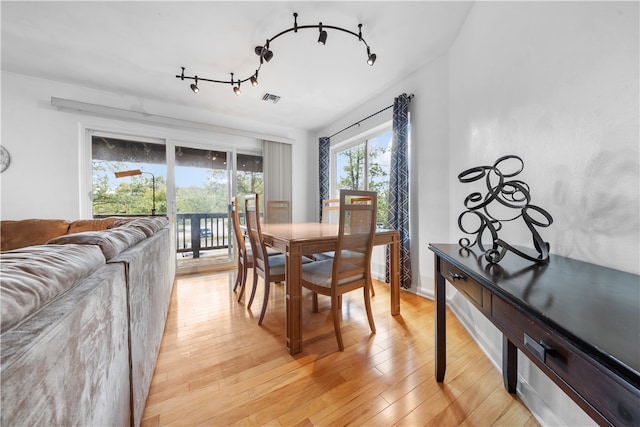 dining space featuring light hardwood / wood-style flooring and vaulted ceiling