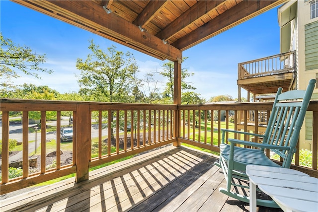 wooden deck with a lawn