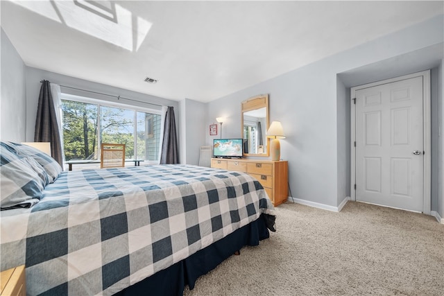 bedroom featuring light carpet