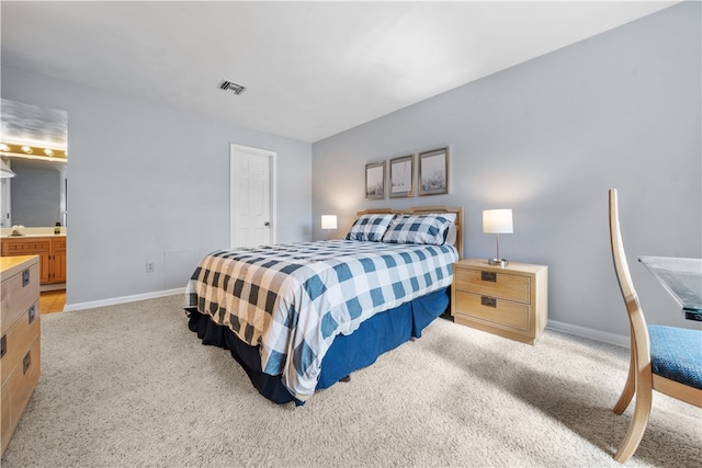 carpeted bedroom with ensuite bathroom