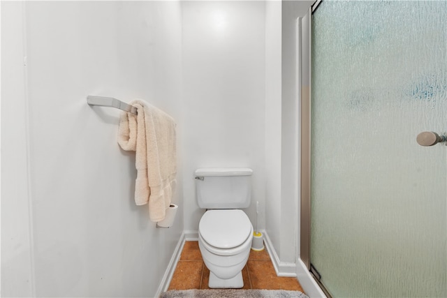 bathroom with tile patterned floors, toilet, and walk in shower