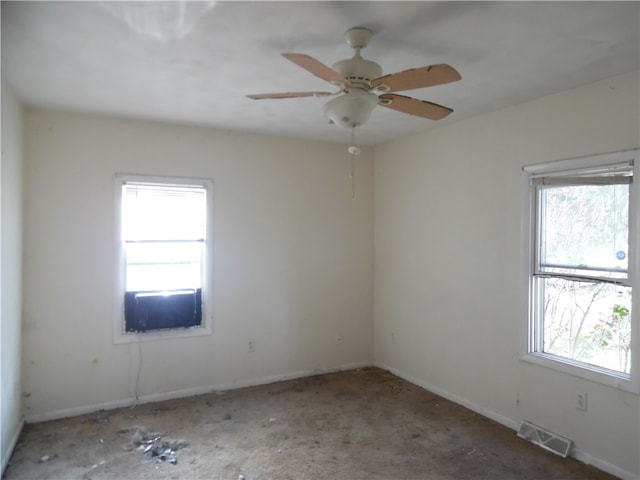 unfurnished room featuring ceiling fan and plenty of natural light