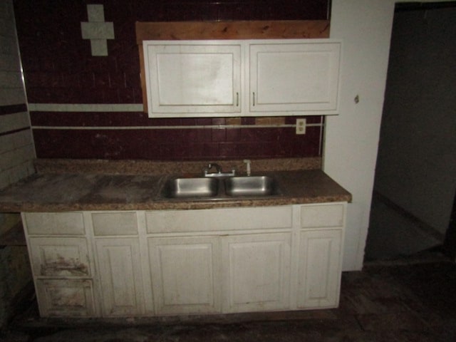 kitchen featuring white cabinetry, tasteful backsplash, and sink