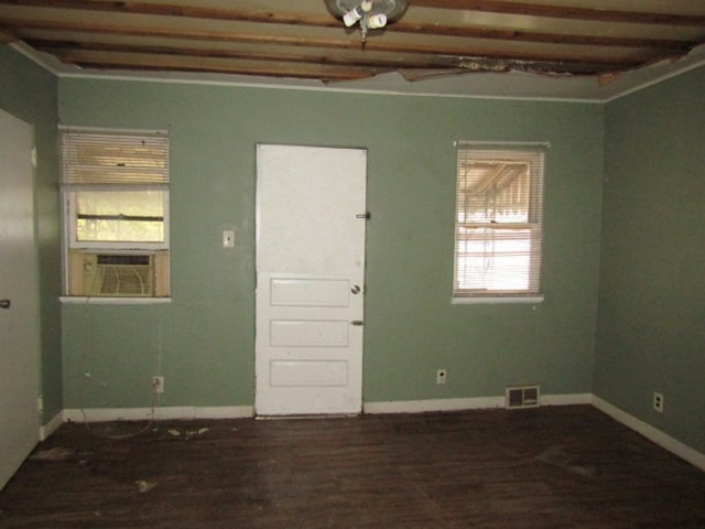 empty room featuring cooling unit and dark hardwood / wood-style flooring