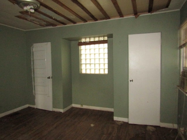 unfurnished room with dark hardwood / wood-style flooring