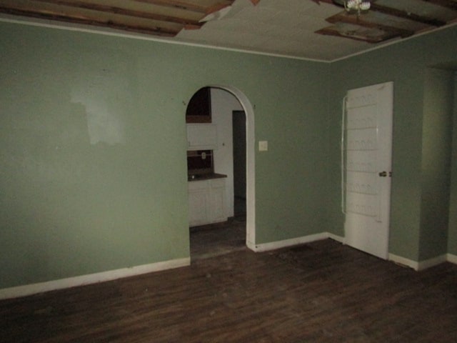 unfurnished room featuring dark wood-type flooring