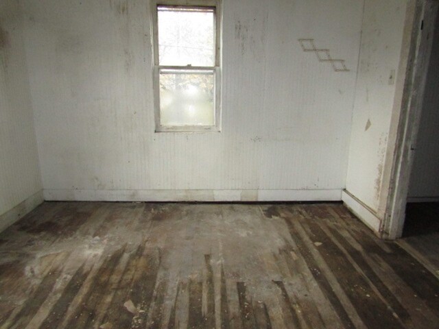 empty room featuring dark hardwood / wood-style flooring