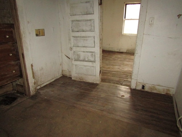 spare room featuring dark wood-type flooring