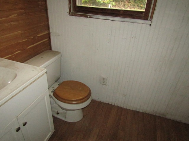 bathroom featuring vanity, hardwood / wood-style floors, toilet, and a wealth of natural light