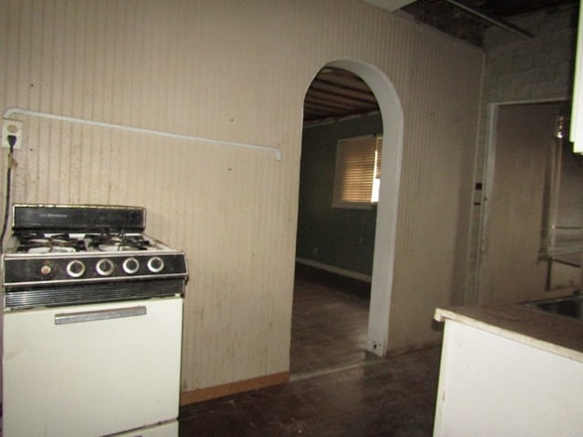 kitchen with white gas range and sink