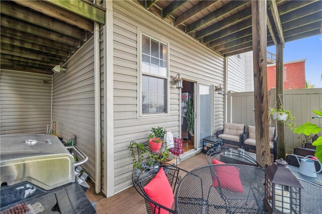 wooden deck featuring a grill and outdoor lounge area