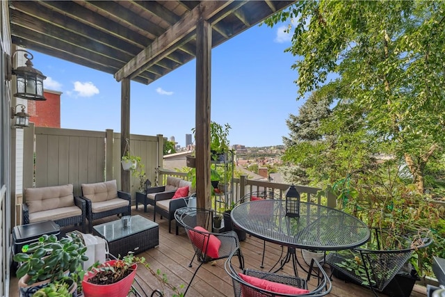 wooden deck with outdoor dining area and outdoor lounge area