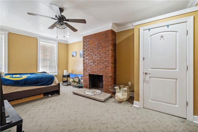 carpeted bedroom with a fireplace, ceiling fan, and crown molding