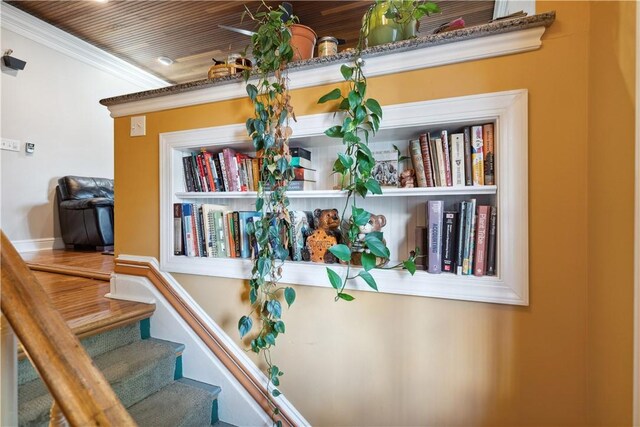 interior space with wooden ceiling, hardwood / wood-style flooring, and crown molding