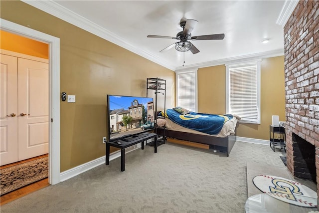 carpeted bedroom featuring a brick fireplace, baseboards, ornamental molding, and ceiling fan