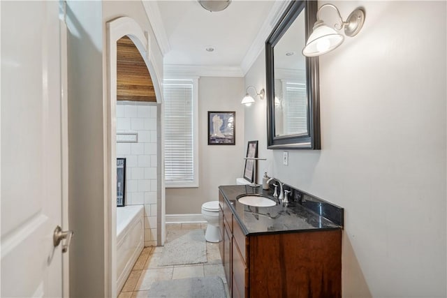 bathroom featuring a tub to relax in, baseboards, toilet, ornamental molding, and vanity