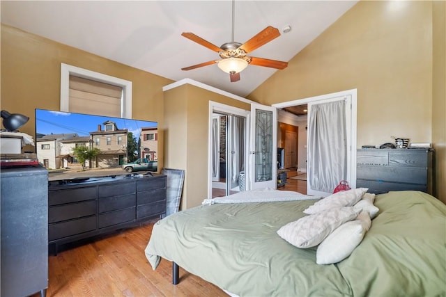 bedroom with lofted ceiling and light wood finished floors