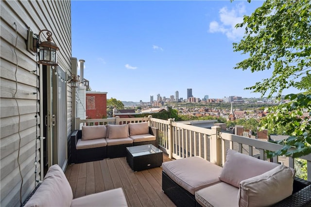 wooden terrace featuring a view of city and outdoor lounge area