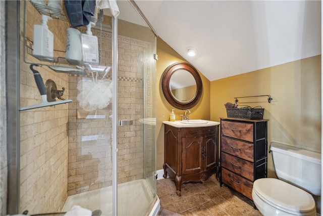 bathroom with vanity, vaulted ceiling, tile patterned flooring, toilet, and a shower with shower door