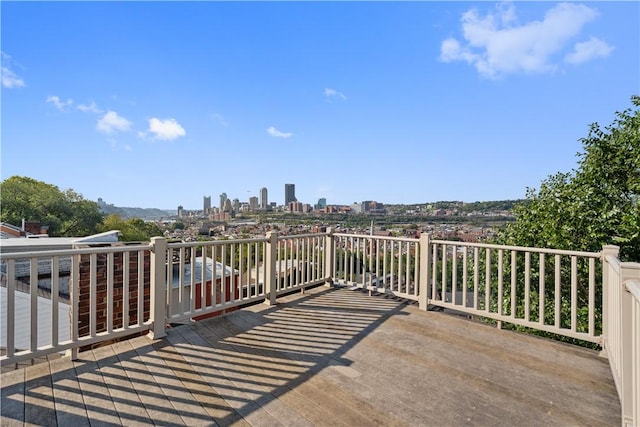 wooden deck with a city view