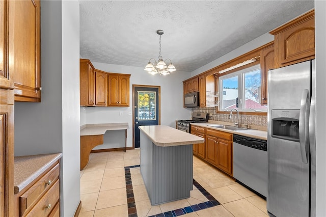 kitchen featuring a kitchen island, stainless steel appliances, sink, pendant lighting, and light tile patterned floors