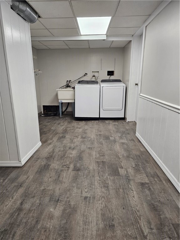 laundry area featuring sink, washing machine and clothes dryer, and wood-type flooring