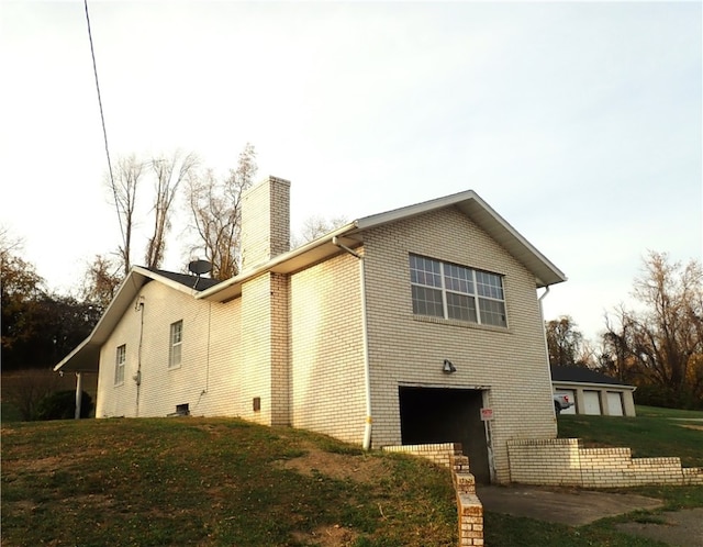 view of side of property featuring a yard and a garage