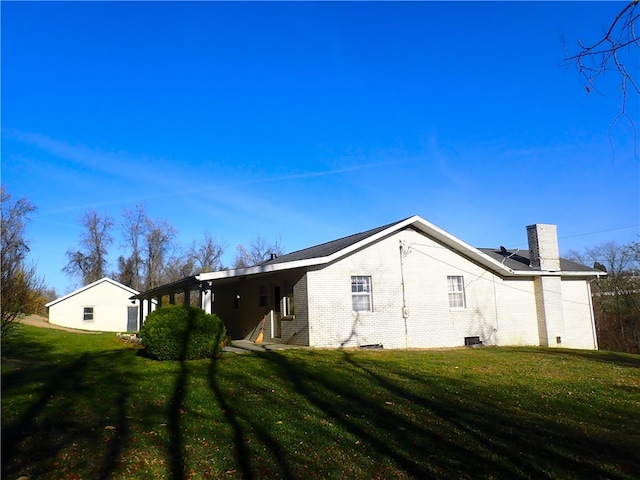 rear view of property featuring a yard