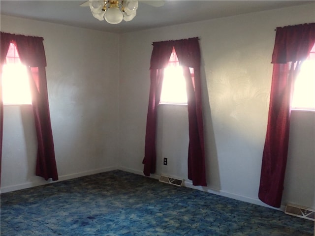 carpeted empty room featuring ceiling fan