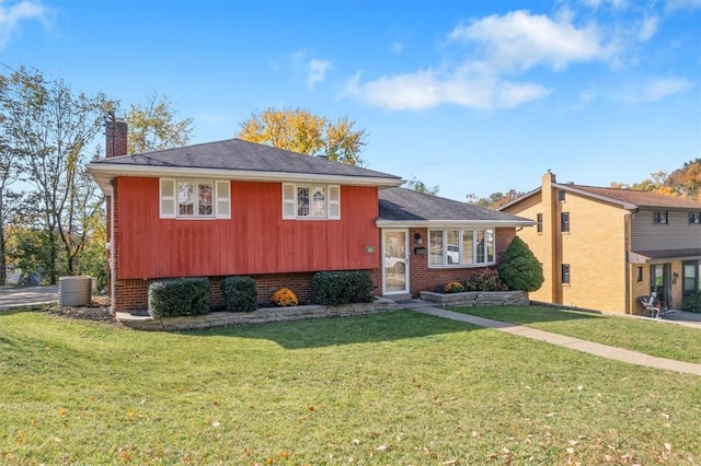 tri-level home with central AC and a front lawn