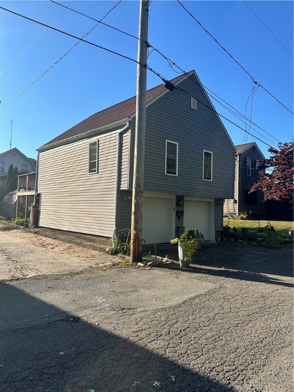 back of property with a garage