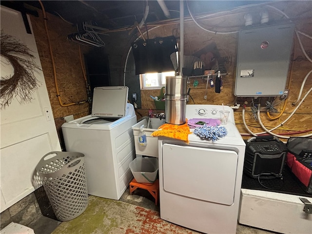 clothes washing area with sink and independent washer and dryer