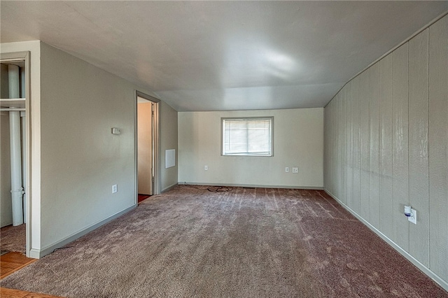 unfurnished bedroom with carpet and vaulted ceiling