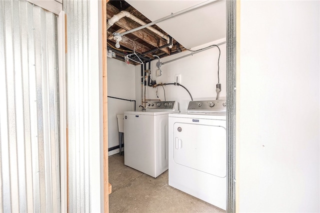 clothes washing area featuring separate washer and dryer